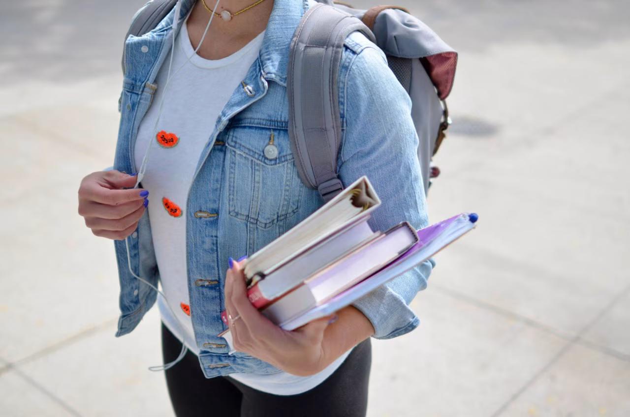 Nieuwsoverzicht 7-13 oktober 2024, persoon met boeken en rugzak buiten, onderweg naar school of leeromgeving