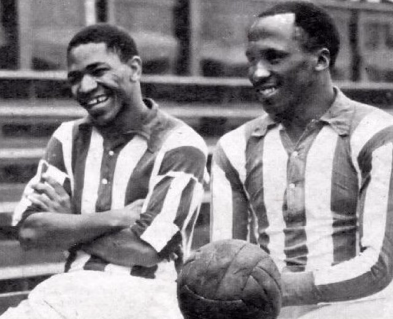 Theaterspektakel in stadion met legendarische heracles voetballers darius dhlomo en steve mokone lachend met oude voetbal